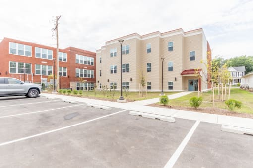 a parking lot in front of an apartment building