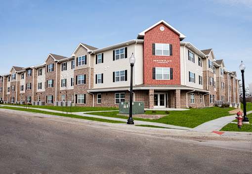 Apartment building with a red fire hydrant in front.