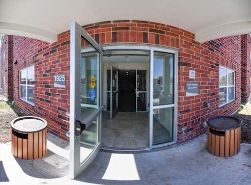 A brick building with a glass door and a sign that says 1925.