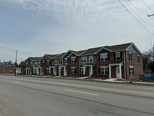 A row of houses with a sign that says "The Brands".