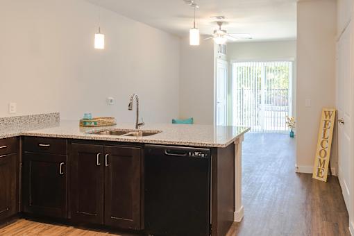A kitchen with black cabinets and a white counter top.