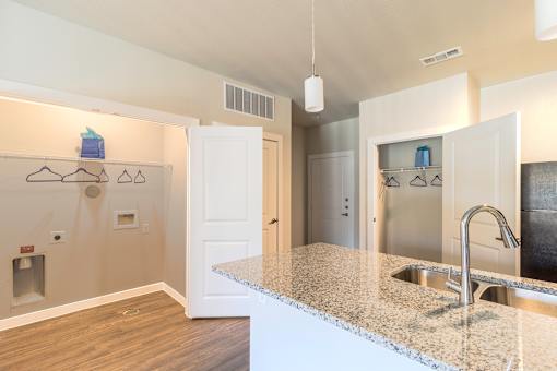 A kitchen with a granite countertop and a sink.