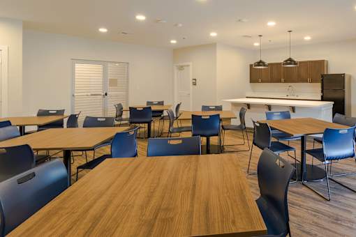 A conference room with a long table and chairs.