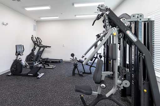 A gym with a variety of equipment including a leg press machine.