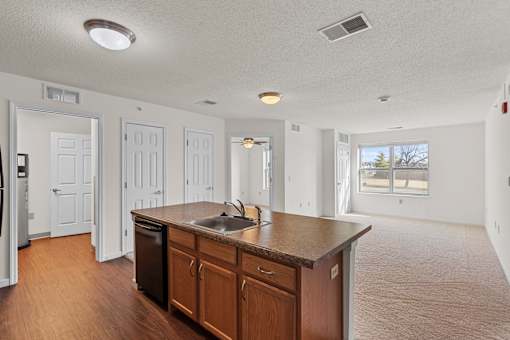 A kitchen with a brown countertop and a sink.