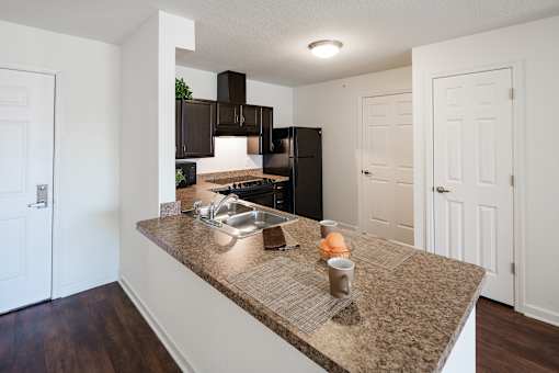 A kitchen with a granite countertop and a sink.