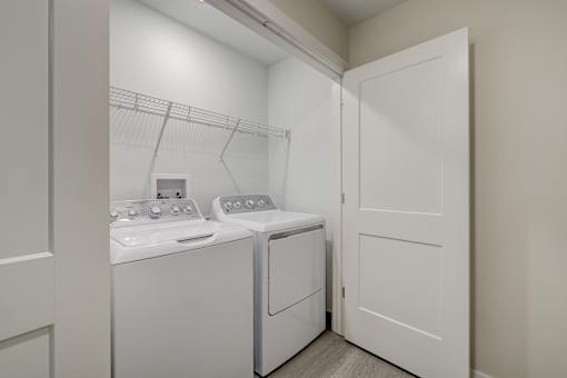 A small laundry room with a washer and dryer.