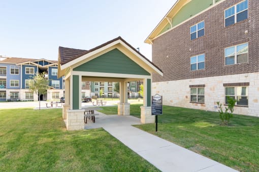 the residences at city center apartments building entrance and grass