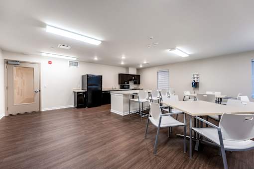A conference room with a long table and chairs.