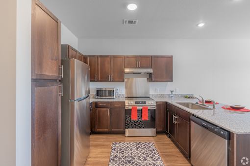 A kitchen with wooden cabinets and a refrigerator.