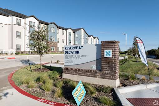 A sign for Reserve at Decatur in front of a building.