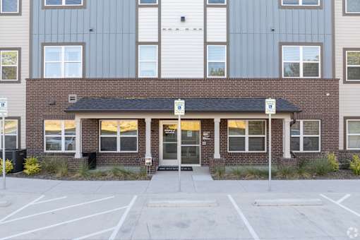 A building with a parking lot in front of it.