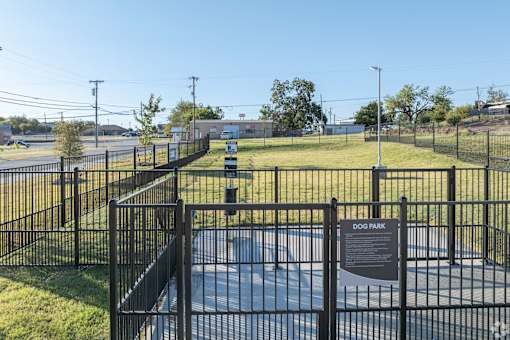 A dog park with a sign that says "DOG PARK" on it.