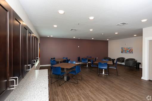 A conference room with a long table and chairs.