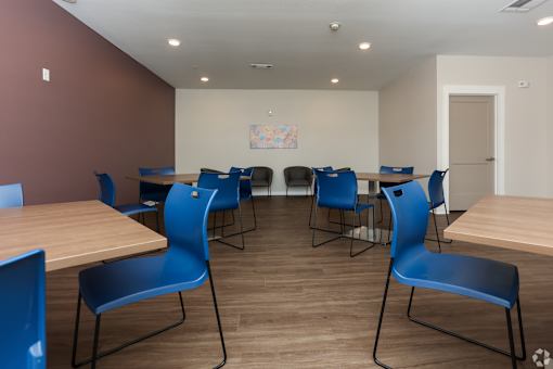 A room with blue chairs and tables.
