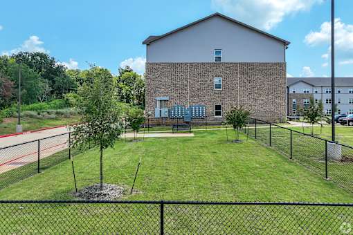 A small building with a fence in front of it.