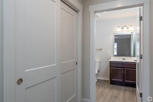 A white door with a round handle is on the left.