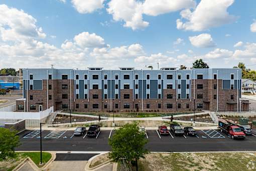A large building with a parking lot in front of it.