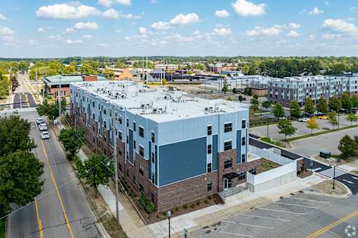 A large building with a parking lot in front of it.