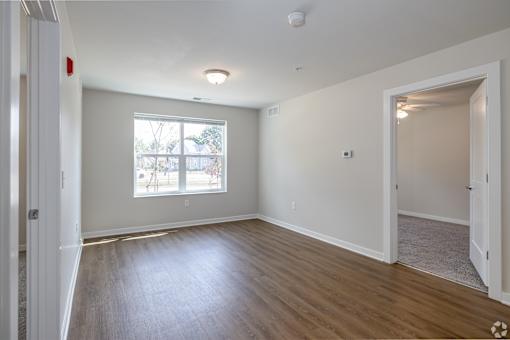 A room with a window and a door.