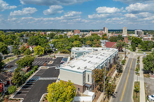 A city street with a white building in the middle.