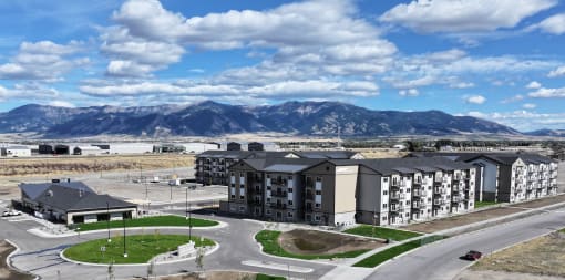 an aerial view of an apartment complex with mountains in the background at Yellowstone Landing, Belgrade, MT
