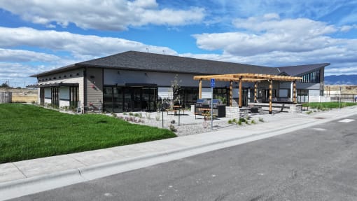 a building with a porch and a street in front of it at Yellowstone Landing, Belgrade, Montana