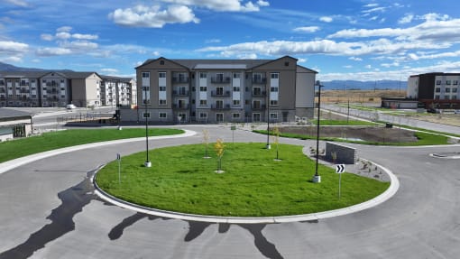 an empty parking lot with an apartment building in the background at Yellowstone Landing, Montana, 59714