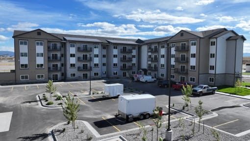a large apartment building with a truck parked in a parking lot at Yellowstone Landing, Montana
