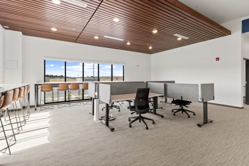 an open office space with desks and chairs and a window at Yellowstone Landing, Belgrade, Montana