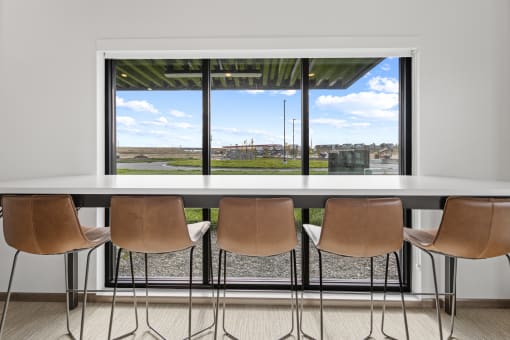 a dining room table with chairs in front of a window at Yellowstone Landing, Montana