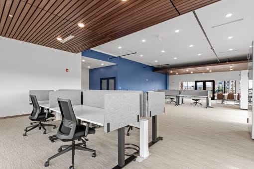 a large office space with desks and chairs and a blue wall at Yellowstone Landing, Montana