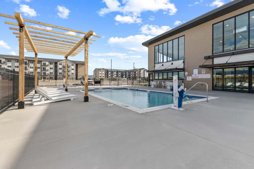 the pool area of a building with a pool and lounge chairs at Yellowstone Landing, Belgrade, MT, 59714