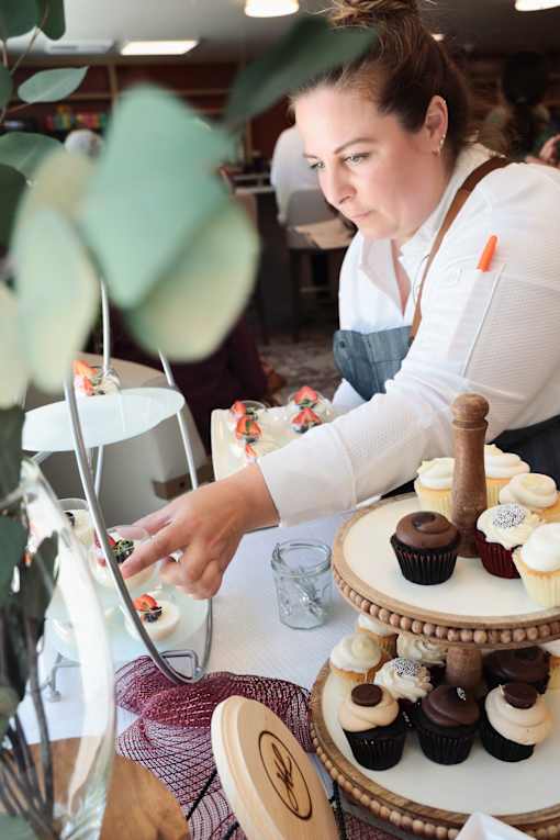 A woman decorates cupcakes at Hearthstone Lodge Senior Residences, Auburn, California