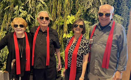 Four people wearing red scarves at Hearthstone Lodge Senior Residences, Auburn, 95602