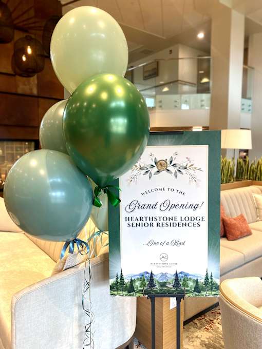 A sign for the Grand Opening at Hearthstone Lodge Senior Residences, Auburn
