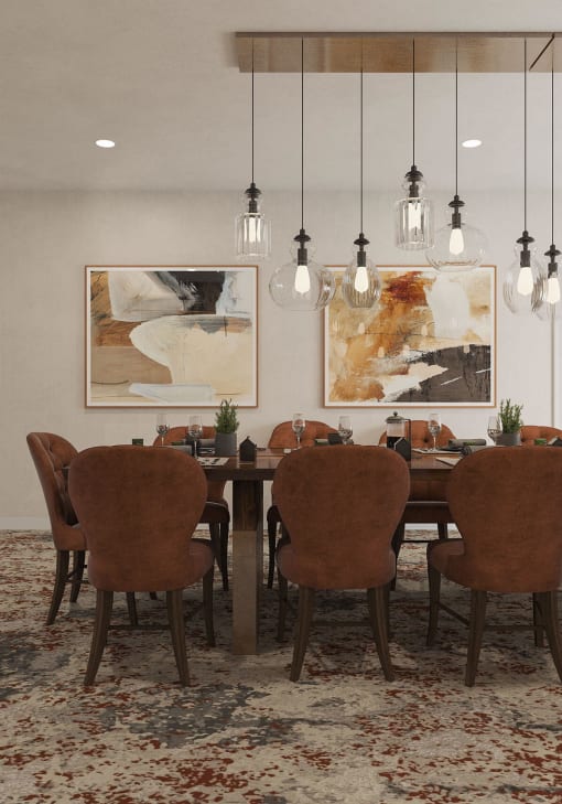 a dining room with a table and chairs and paintings on the wall at Hearthstone Lodge Senior Residences, Auburn California