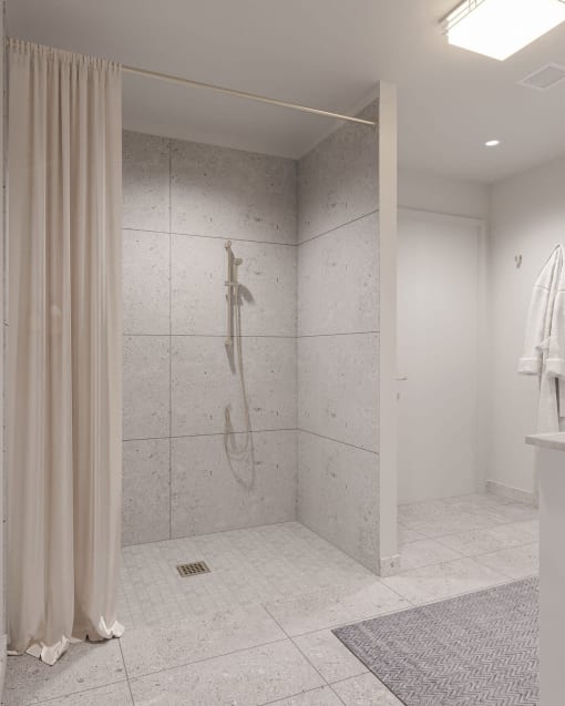 a bathroom with a shower and a shower curtain at Hearthstone Lodge Senior Residences, California