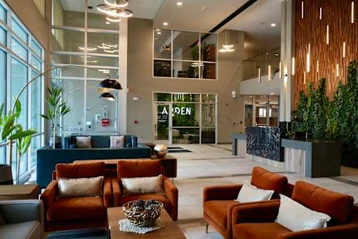 A large room with a reception desk and couches.
