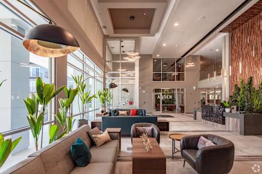 a lobby with couches and chairs and a large window