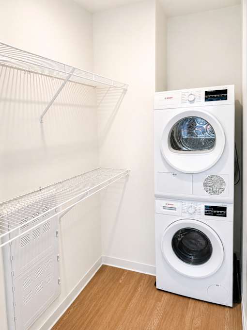Laundry room with stacked washer and dryer at Textile Lofts Apartments, Cincinnati