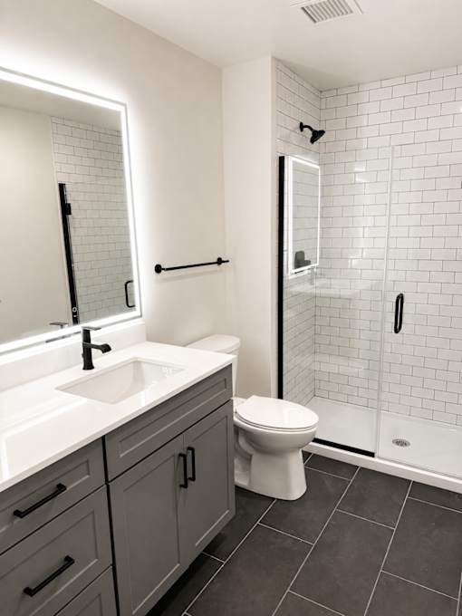 Modern bathroom with white subway tile shower at Textile Lofts Apartments, Ohio, 45202