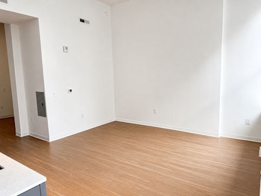 Empty living room with wood flooring at Textile Lofts Apartments, Cincinnati, Ohio