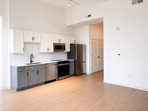 Open concept kitchen with two tone cabinets at Textile Lofts Apartments, Cincinnati, 45202