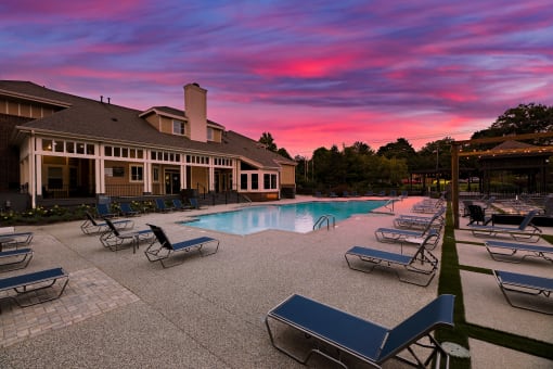 swimming pool with clubhouse in the background at sunset  at Butternut Ridge, North Olmsted, OH