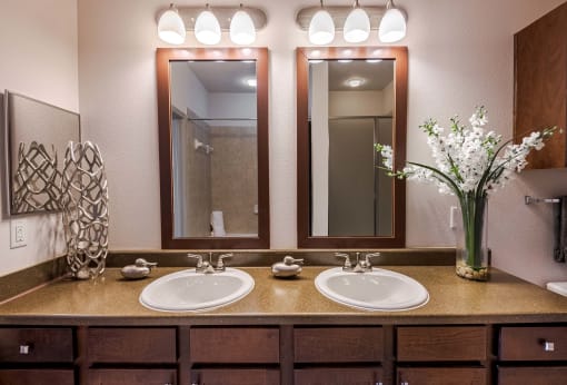 a bathroom with two sinks and two mirrors at Discovery at Craig Ranch, McKinney, 75070