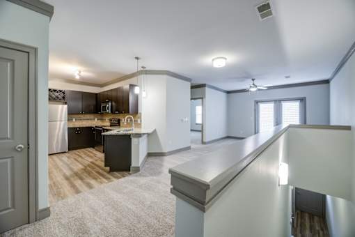 A kitchen with a refrigerator, oven, and sink.
