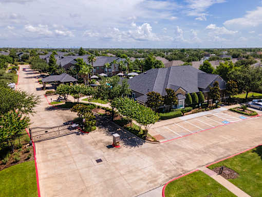A residential area with houses and a parking lot at Avenues at Shadow Creek Ranch Apartments, Pearland, 77584