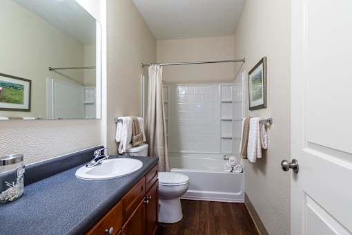 A bathroom with a toilet, sink, and shower. at CityView, North Kansas City, Missouri