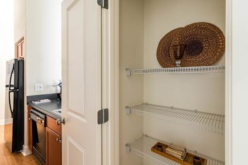 A kitchen with a stove and a hat on the shelf. at CityView, North Kansas City, Missouri